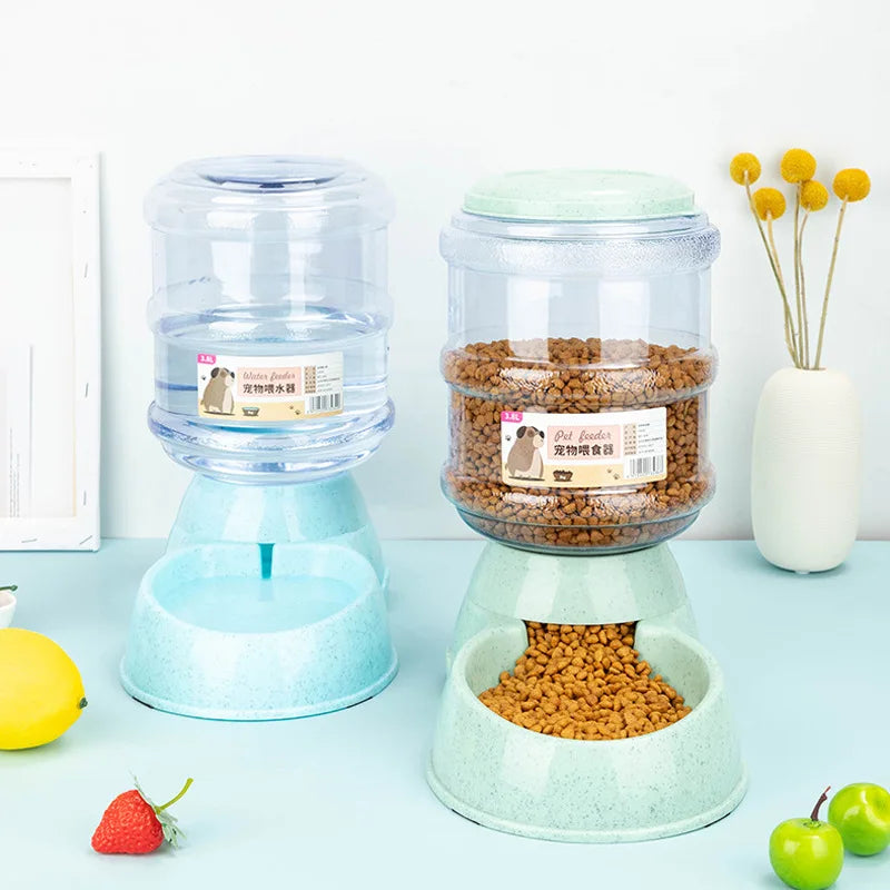 Two automatic pet feeders with clear water and food dispensers atop speckled blue and green plastic bowls.