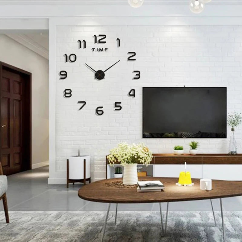 Modern black acrylic DIY wall clock with large 3D-effect numbers mounted on a white brick living room wall.