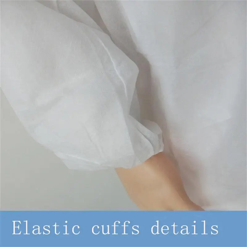 Close-up of a white, non-woven protective gown sleeve featuring a secure, gathered elastic cuff.