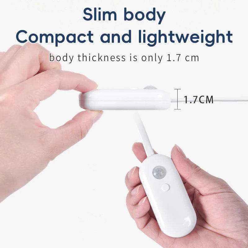 Slim white USB rechargeable motion sensor light being held to show its compact 1.7cm thickness.