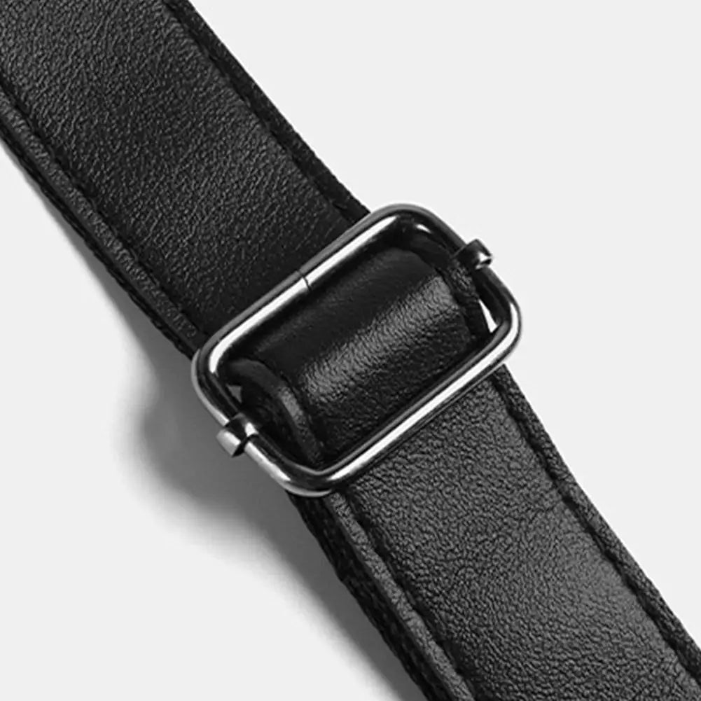 Close-up of a black textured faux leather adjustable bag strap with a matte gunmetal metal buckle.