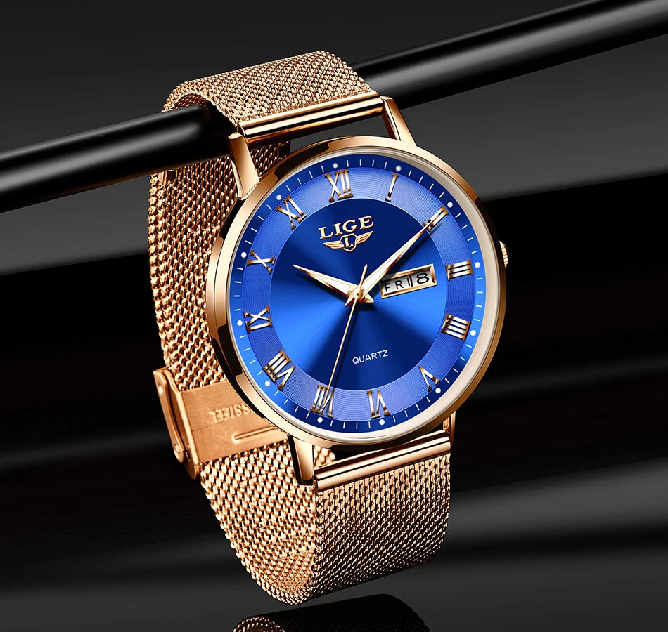 Elegant women’s rose gold mesh bracelet watch featuring a circular, vibrant blue sunray dial with Roman numerals.