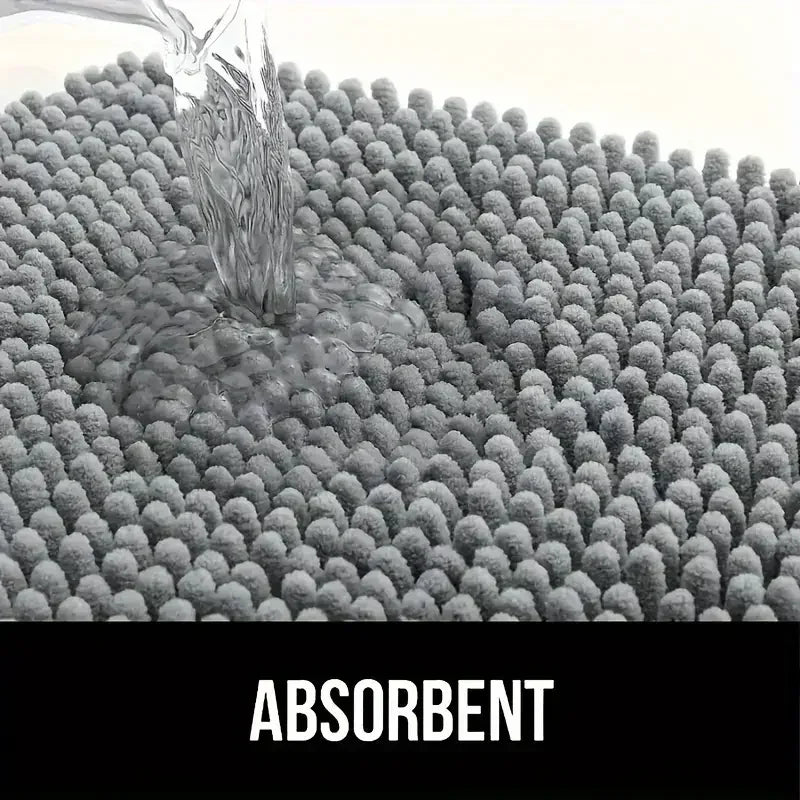 Water being poured onto a grey, textured chenille dog doormat, demonstrating its high absorbency.