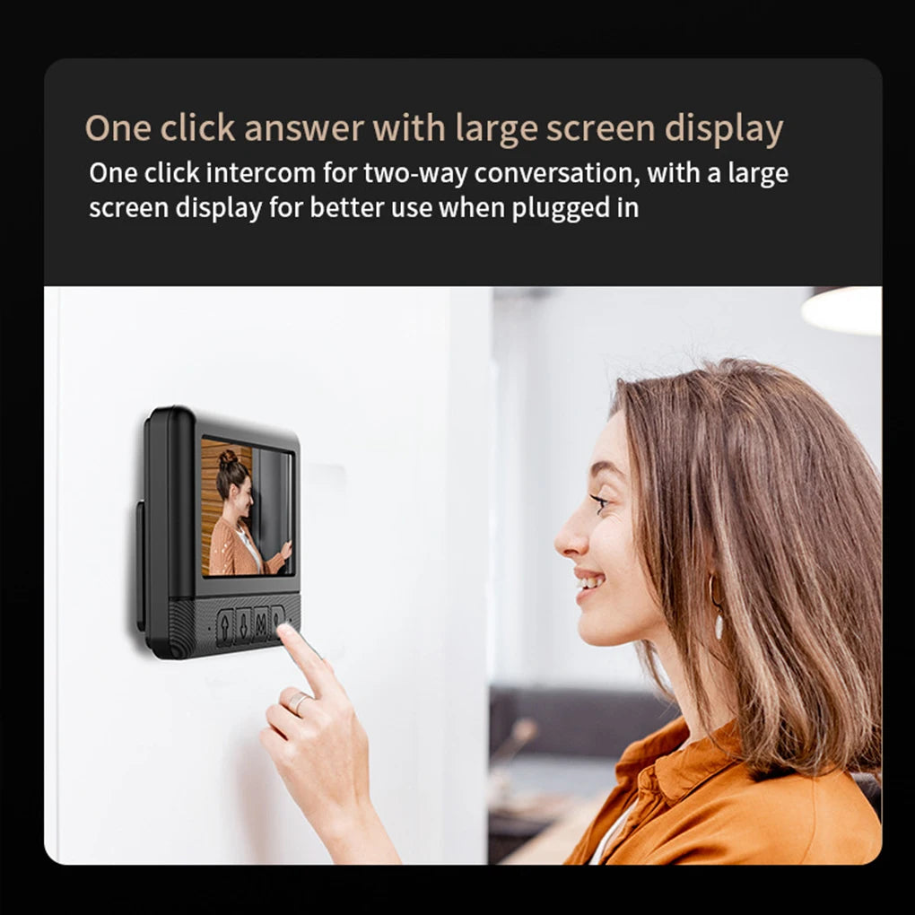 A woman using a black, wall-mounted wireless video doorbell with a 4.3-inch screen and two-way talk features.