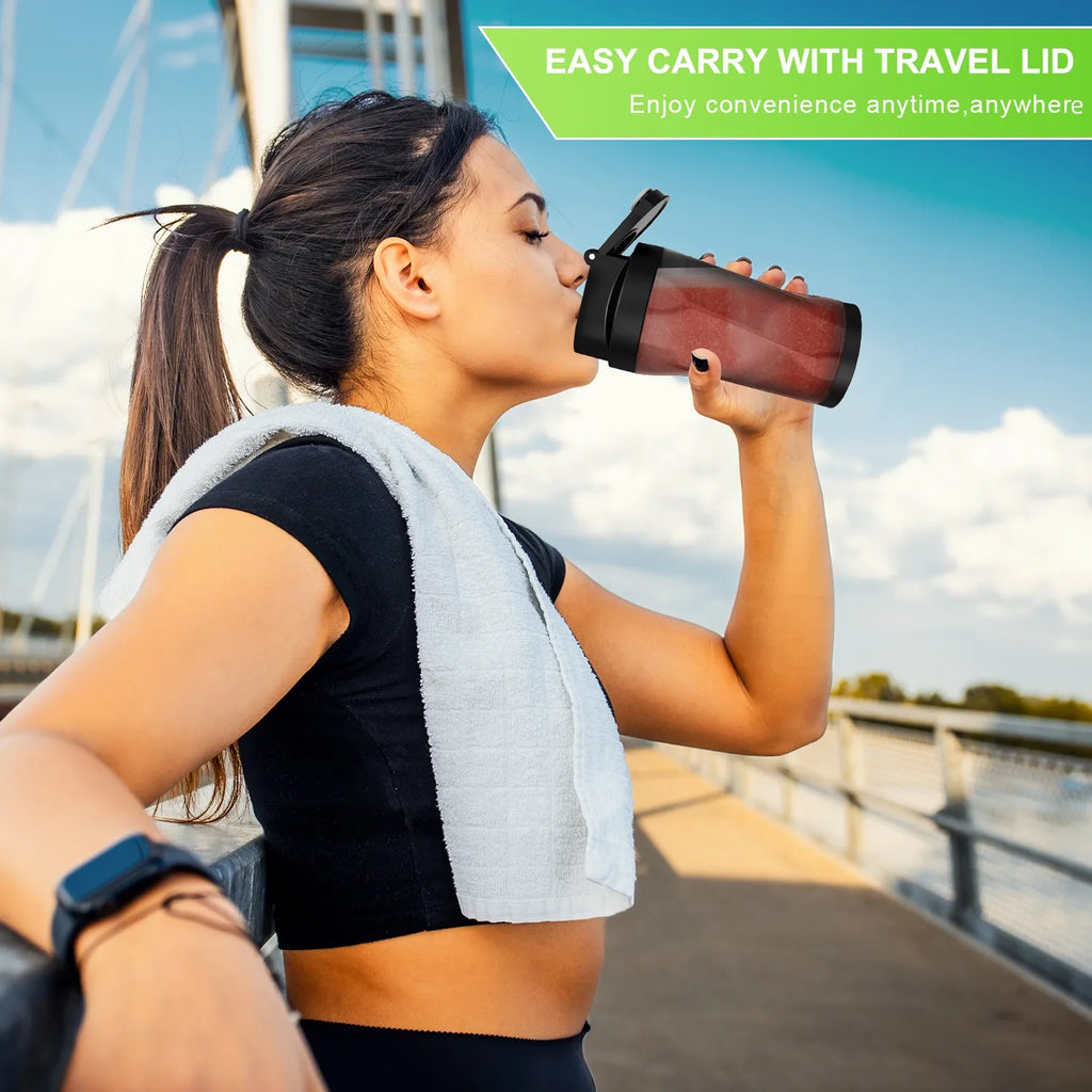 A woman drinks from a sleek black travel protein shaker bottle with a secure flip-top lid outdoors.