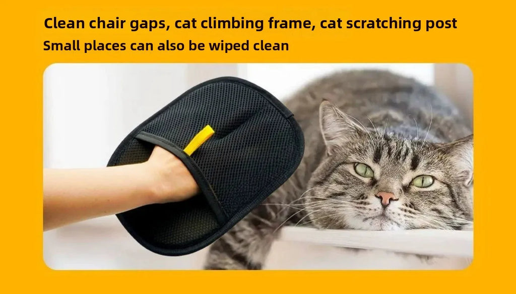 Black mesh cleaning mitt with a yellow tab on a person's hand, placed next to a resting tabby cat.
