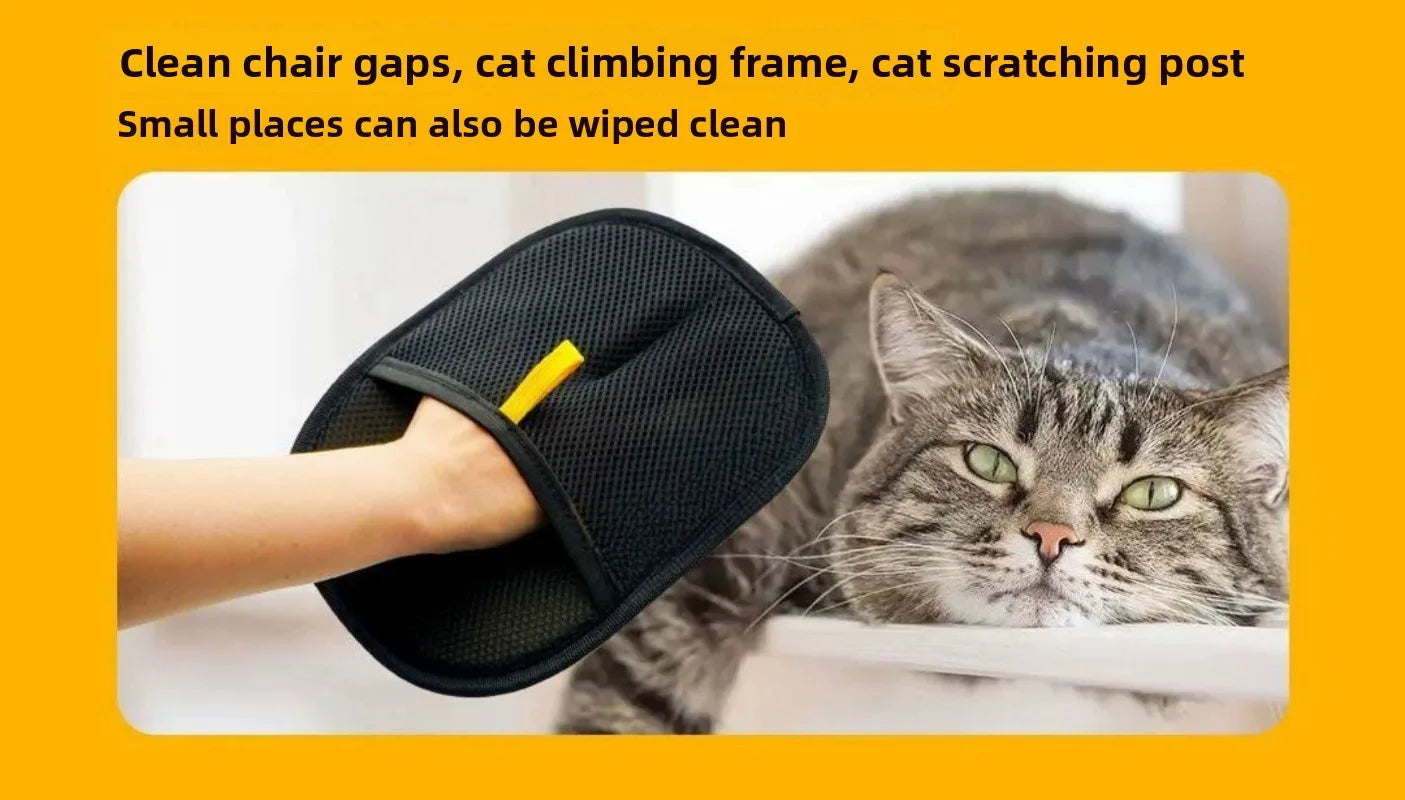 Black mesh cleaning mitt with a yellow tab on a person's hand, placed next to a resting tabby cat.