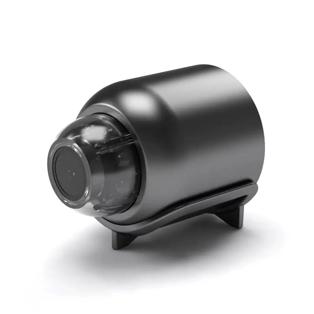 Compact matte black metal security camera with a spherical lens housing on a small integrated stand.