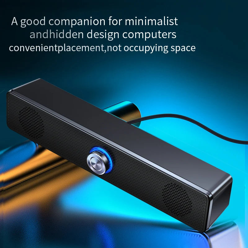 Sleek, black wired USB stereo soundbar with a central silver volume dial featuring blue LED lighting.