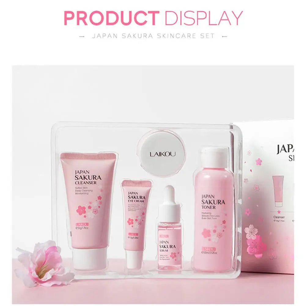 A Sakura-themed pink skincare set containing cleanser, eye cream, serum, toner, and cream in a gift box.