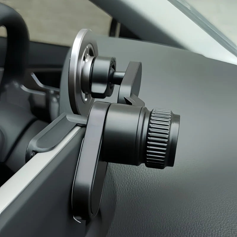 Black, adjustable magnetic car phone mount attached to a vehicle dashboard with a sleek, minimalist design.