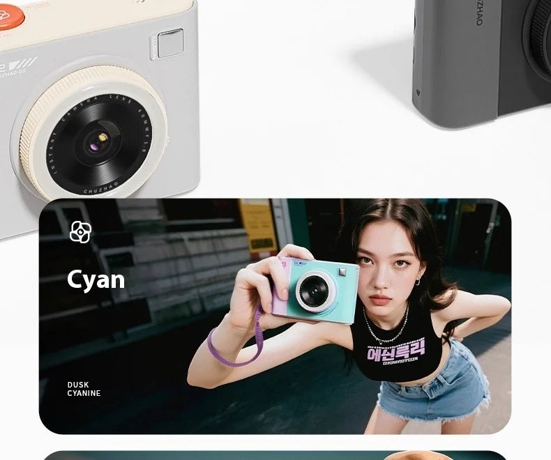 A person holding a cyan and purple plastic instant camera with a lens and a wrist strap.