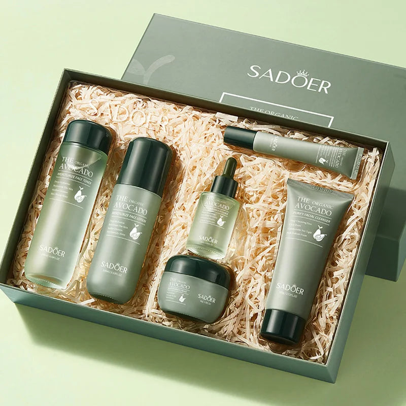 A 5-piece organic avocado skincare gift set in sage green packaging, including cleanser, toner, lotion, serum, and cream.