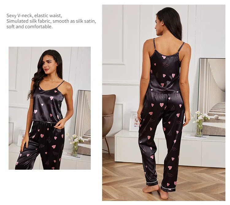 Black satin pyjama set with pink heart print, featuring a V-neck camisole and elastic-waist trousers.