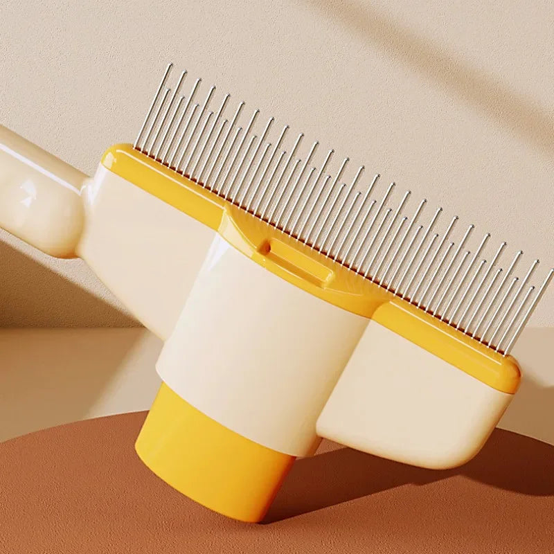 Cream and yellow pet grooming comb with a row of silver metal pins, set against a minimalist studio background.