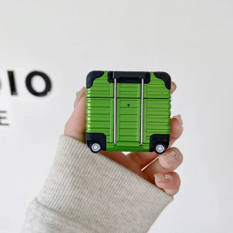 Green suitcase-style silicone AirPods case with wheels and trolley handle design.