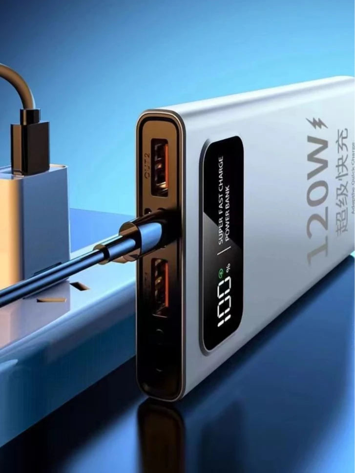 Silver 20000mAh fast-charging power bank with an LED display showing 100% battery and multiple USB output ports.
