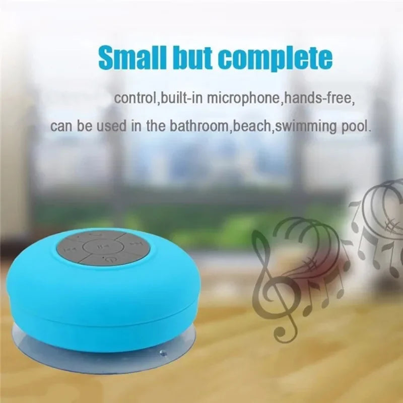 Bright blue, compact wireless waterproof speaker with a grey control panel and suction cup base for easy mounting.
