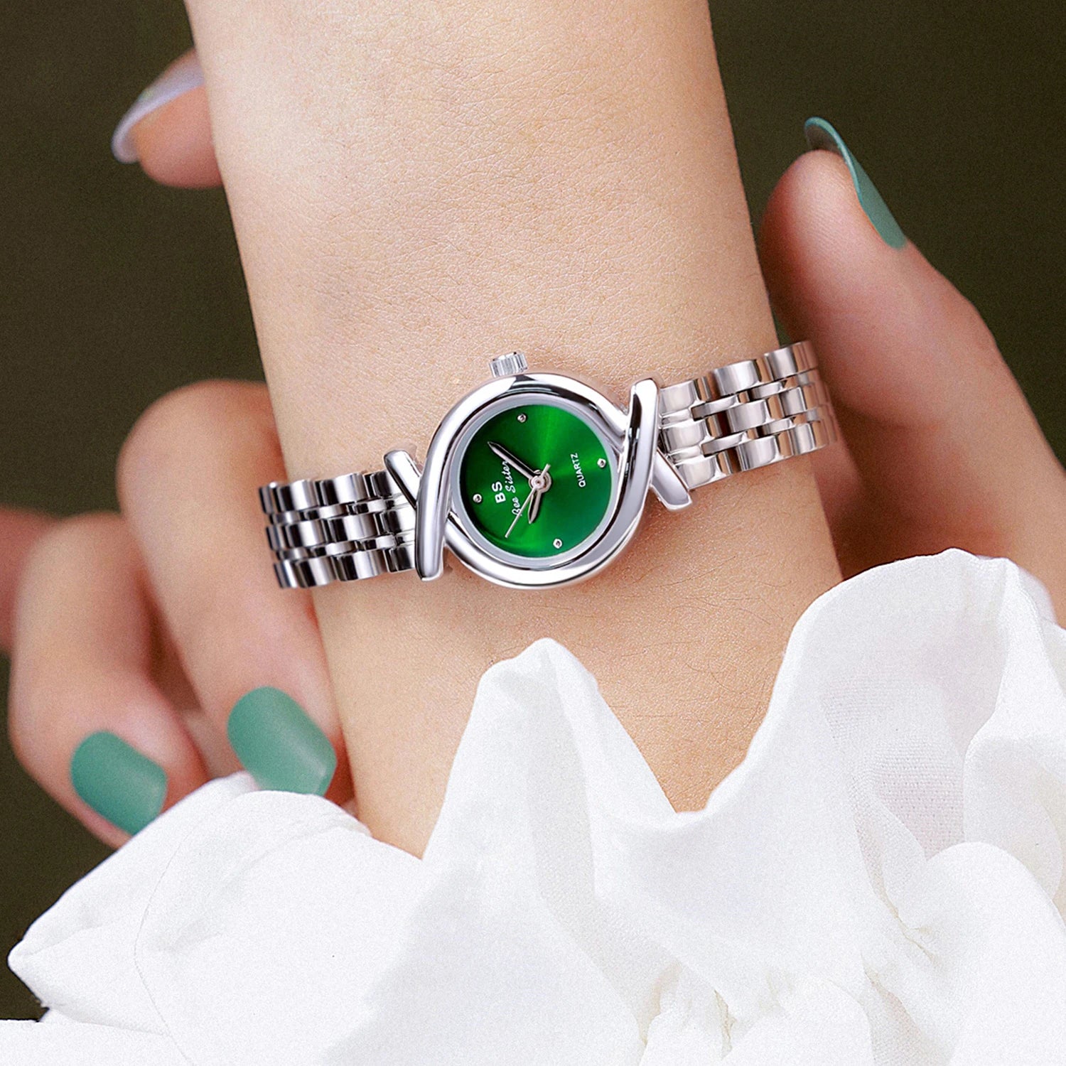 Women's elegant quartz wristwatch with a polished silver-tone bracelet and a striking round emerald green dial.