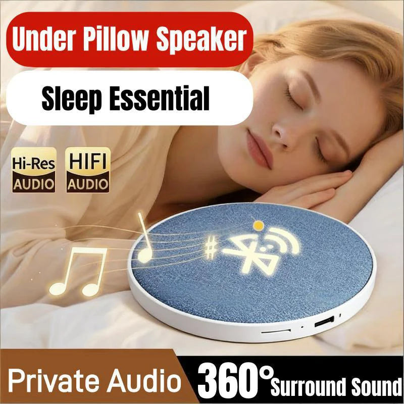 A sleek, blue fabric-covered circular wireless speaker for use under a pillow, providing 360° surround sound.
