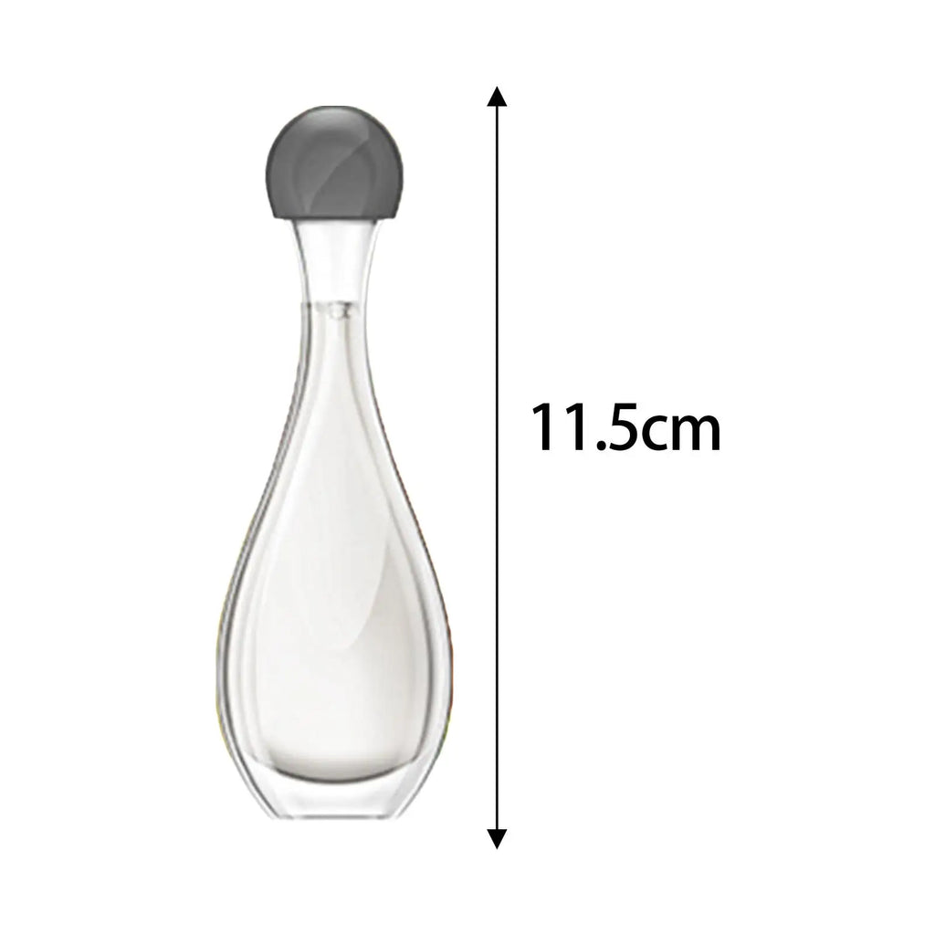 Clear, teardrop-shaped perfume bottle with a round grey cap, measuring 11.5cm in height.