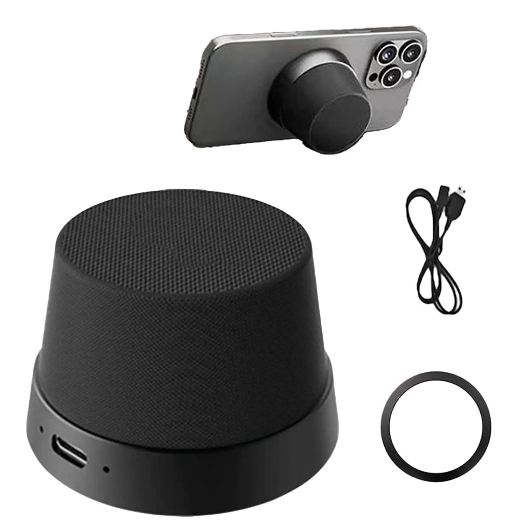 Black magnetic wireless speaker with charging cable and metal ring, shown attached to the back of a smartphone.