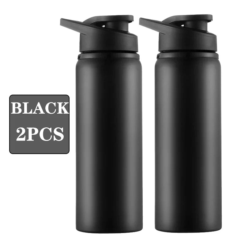 Two matte black reusable water bottles with black flip-top lids, displayed side-by-side against a white background.