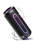 Black, cylindrical waterproof Bluetooth speaker with purple LED lights, control buttons, and water splashes.