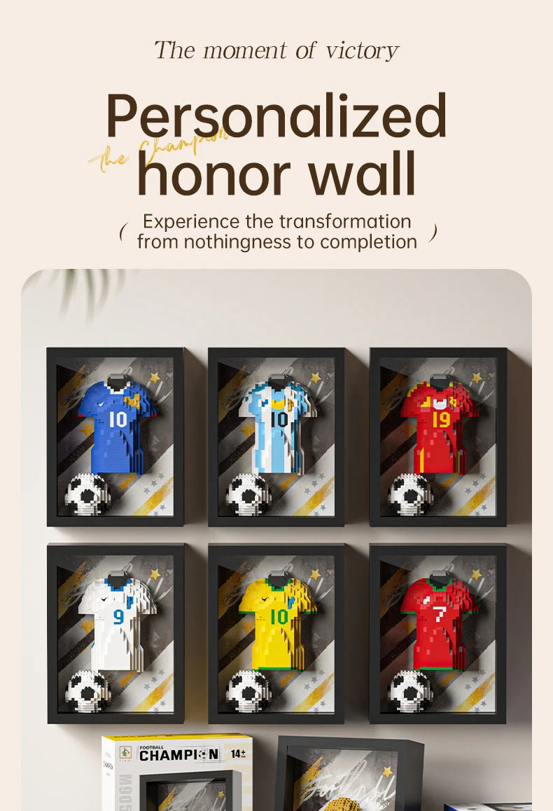 Six framed 3D brick art displays showing various colourful football jerseys and a ball on a wall.