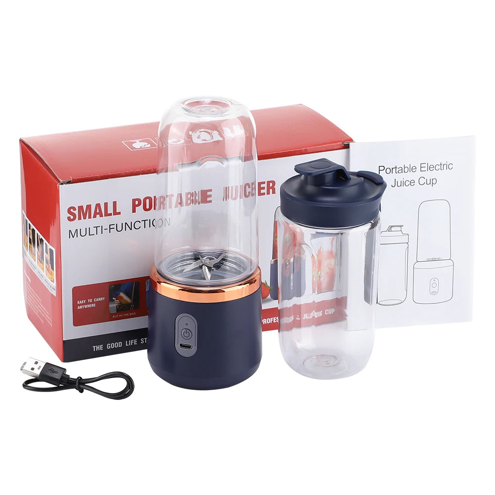 Portable electric juicer in navy blue with a rose gold accent, clear cup, charging cable, and product box.