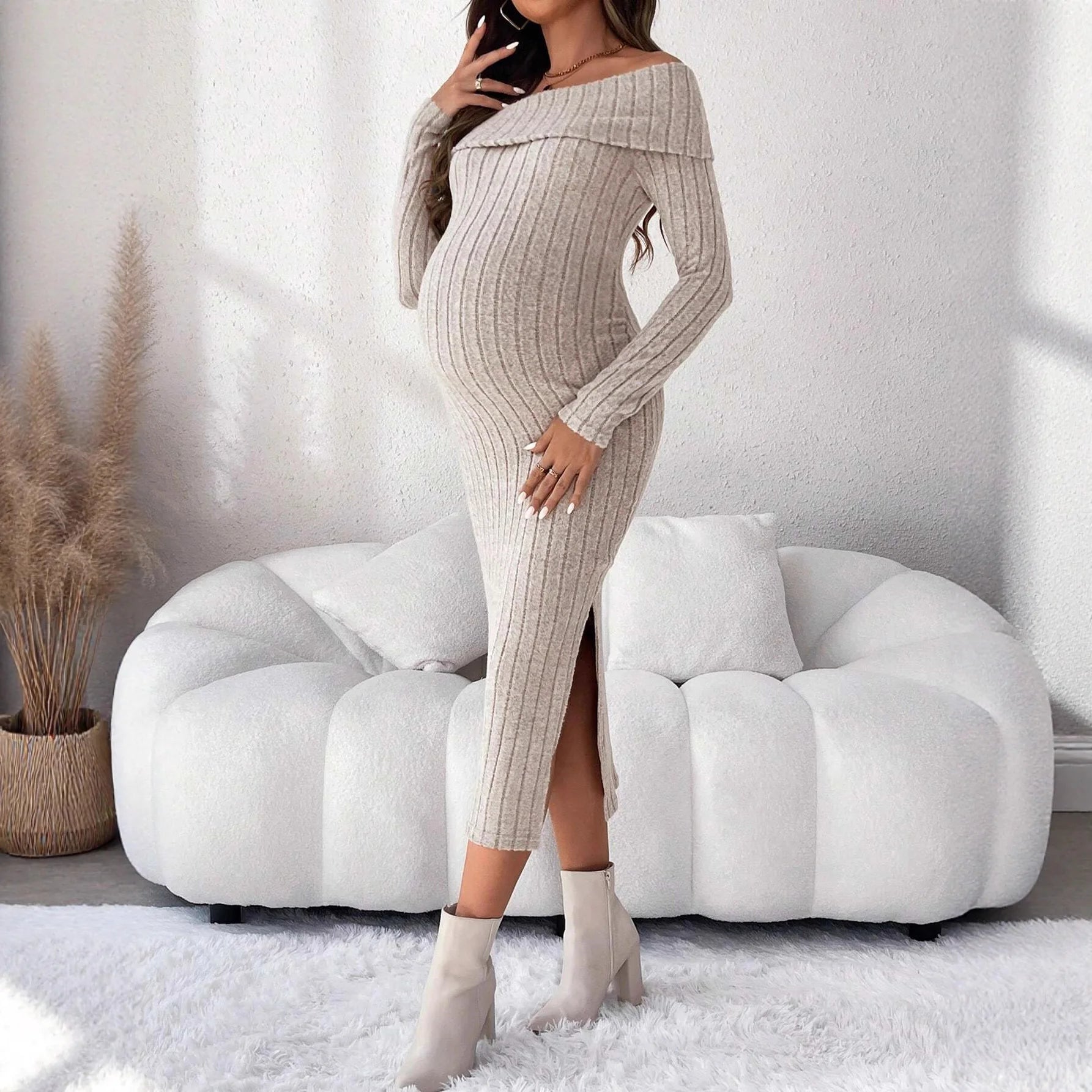 Beige ribbed maternity midi dress with off-the-shoulder neckline, long sleeves, and side slit.
