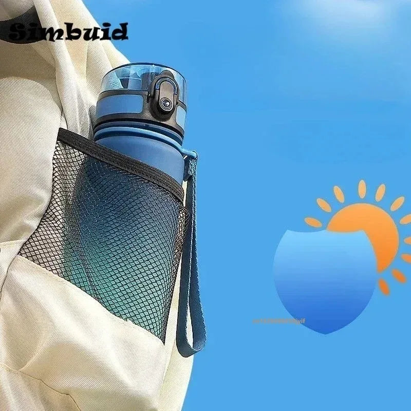 Blue plastic sports water bottle with a carry strap, stored in the mesh pocket of a cream-coloured backpack.