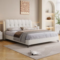 Modern minimalist cream white storage bed frame with an upholstered, tufted headboard and integrated side lighting.