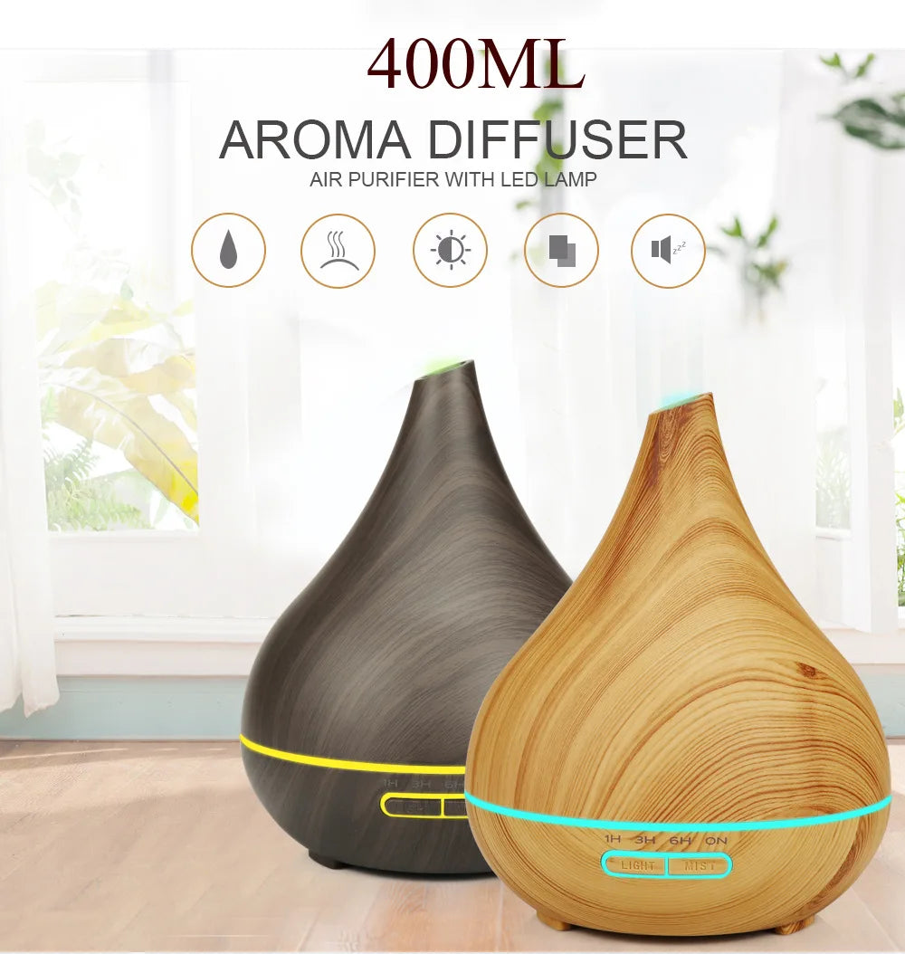 Two 400ml teardrop-shaped diffusers in dark and light wood grain finishes with glowing LED bands and button controls.
