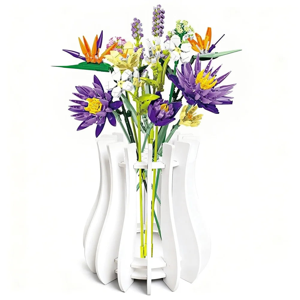 A vibrant bouquet of artificial block-built flowers in purple, orange, and yellow, displayed in a modern white vase.