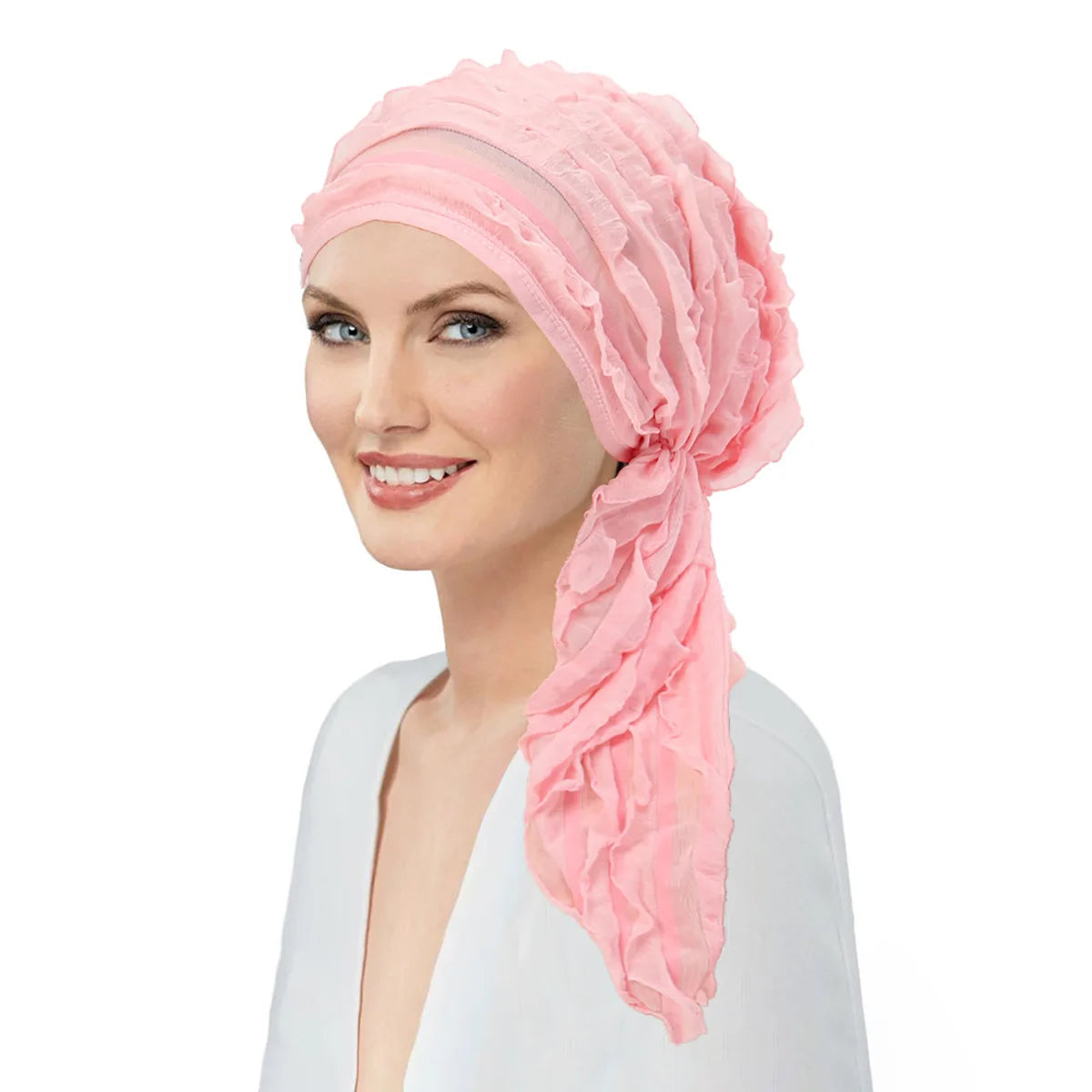 Model wearing a soft pink, pre-tied ruffle turban head wrap with a decorative side sash.