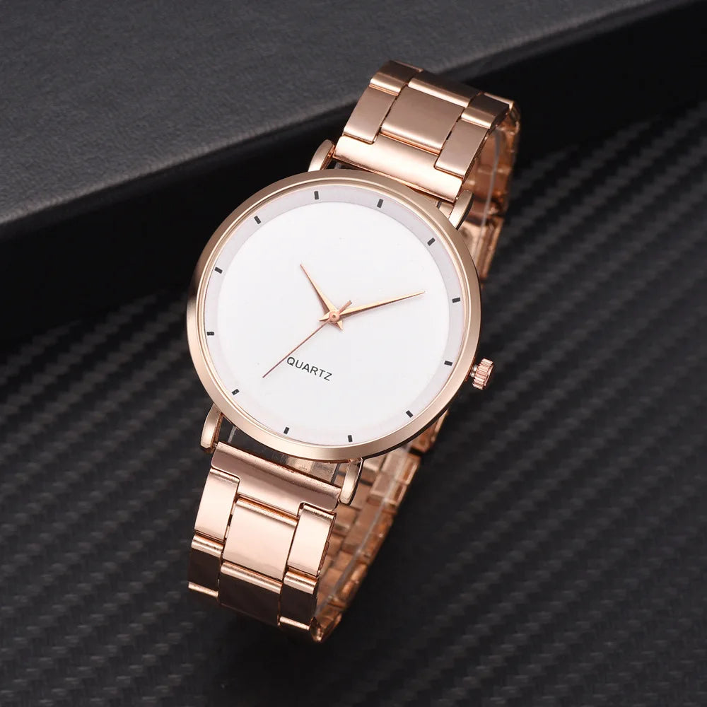 Elegant ladies' rose gold stainless steel watch featuring a minimalist white face and polished link bracelet.