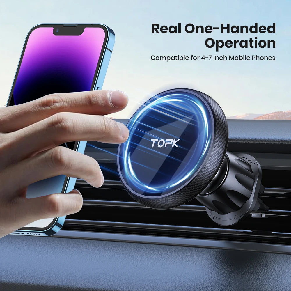 A black, circular magnetic car phone mount attached to an air vent, shown with a hand docking a blue smartphone.