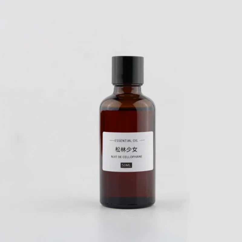50ml amber glass bottle of essential oil with a black screw cap and a minimalist white product label.