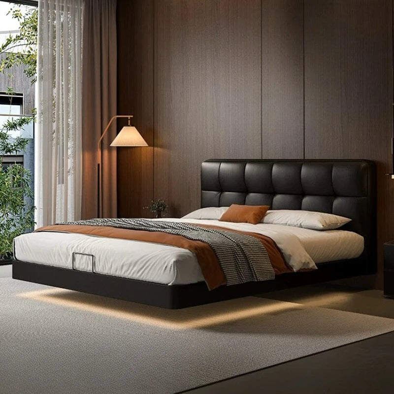 Luxury black leather floating double bed with a tufted headboard and integrated warm under-bed LED lighting.
