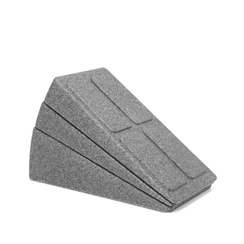 Grey felt-covered adjustable wedge pillow with three stacking layers for height support.