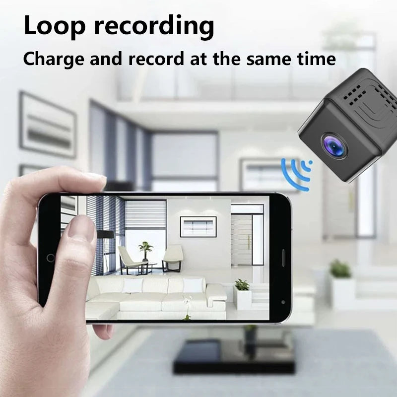 Small black cube wireless security camera streaming a live indoor view to a smartphone.