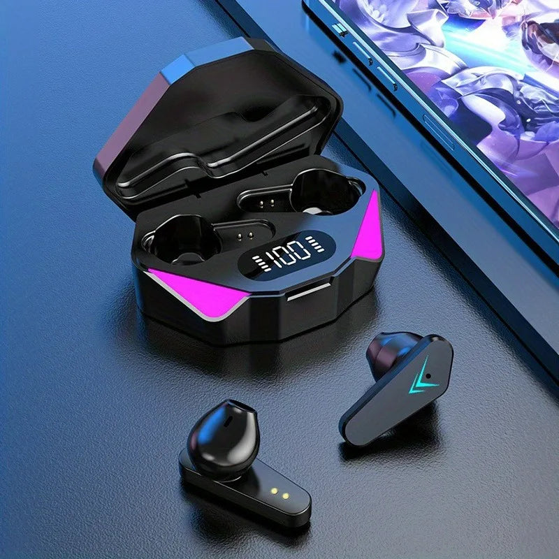 Black wireless gaming earbuds with neon lights and a digital battery display charging case on a blue desk.