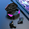 Black wireless gaming earbuds with neon lights and a digital battery display charging case on a blue desk.