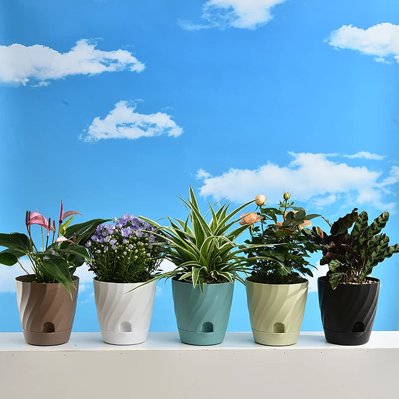 Five modern, swirl-textured plastic plant pots in various colors line a shelf against a bright blue sky background.