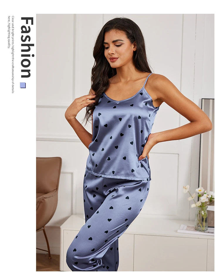 Blue satin pyjama set with camisole and matching trousers featuring a black heart print.