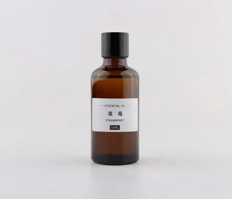 50ml brown glass bottle of strawberry essential oil with a black screw-top lid and minimalist white label.