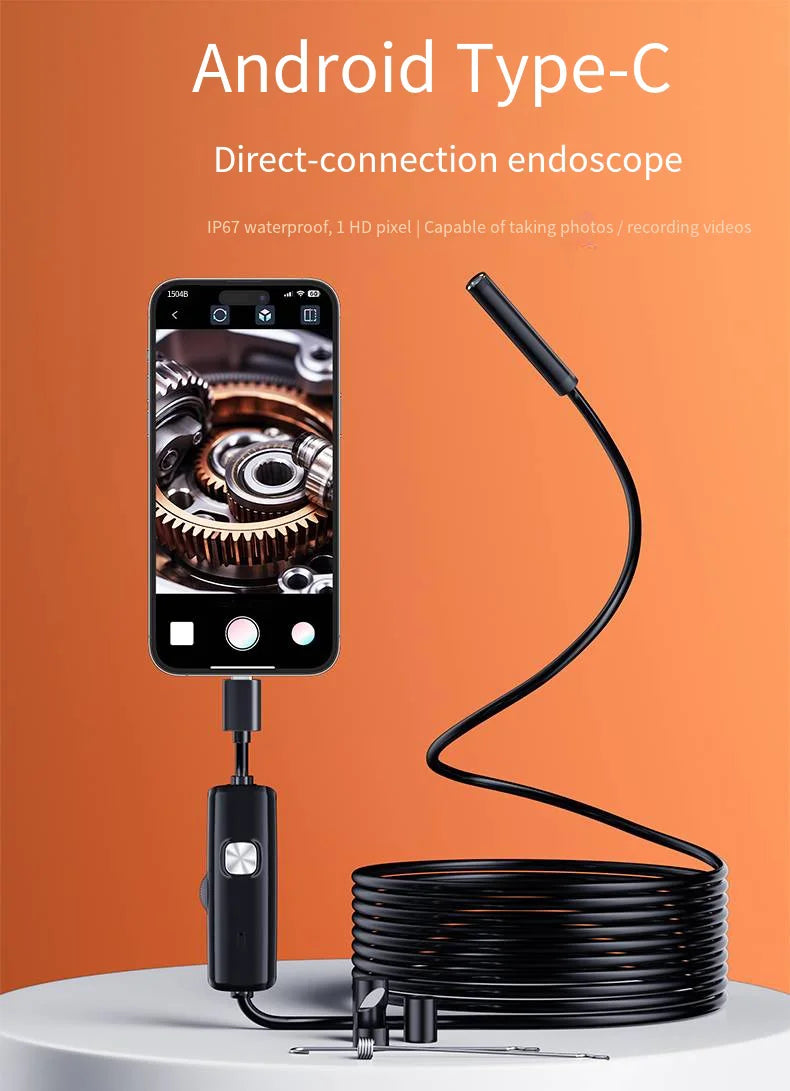 Black USB-C endoscope camera connected to a smartphone, showing a mechanical gear view on the screen.