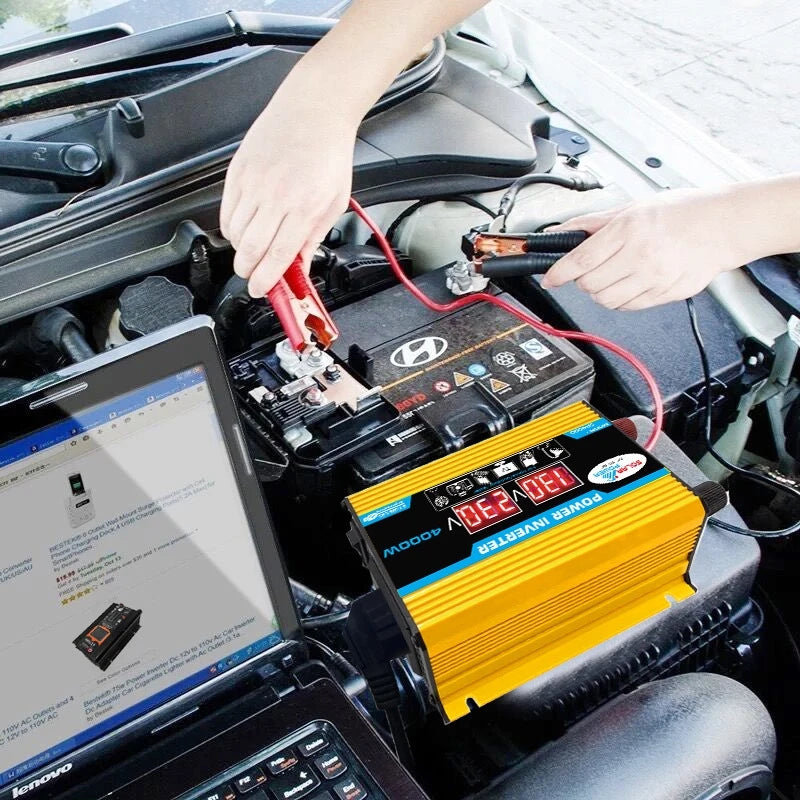Yellow 4000W car power inverter with digital display, connected to a car battery and laptop.