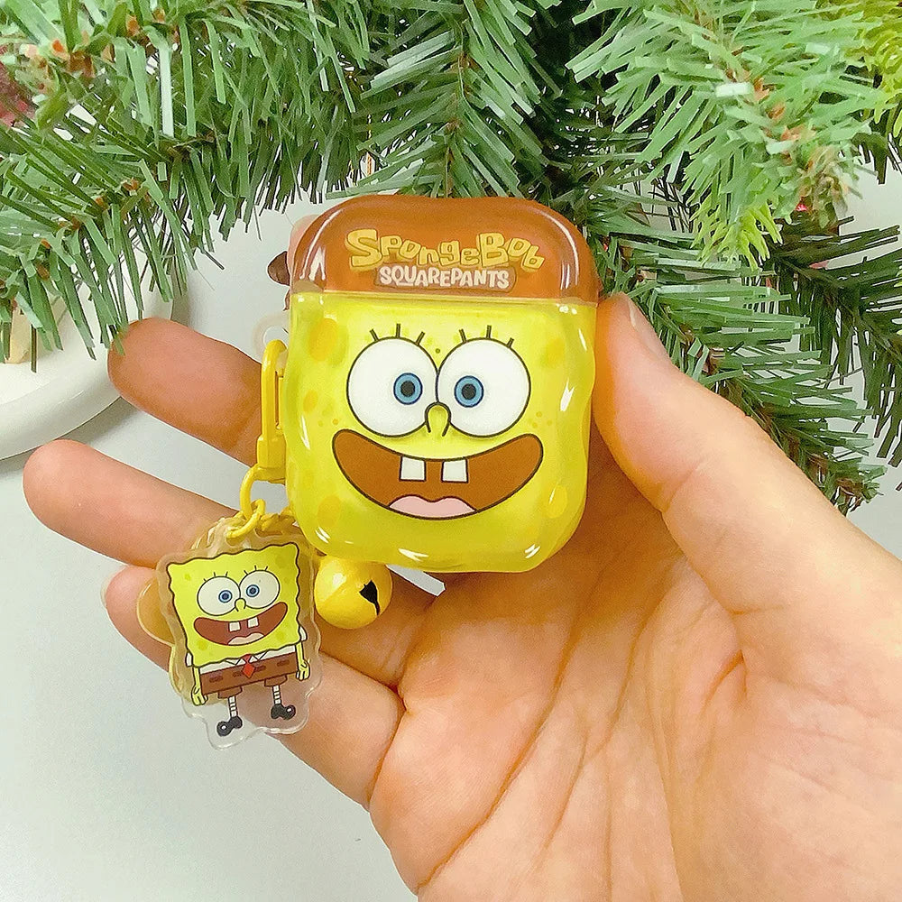 Yellow Spongebob Squarepants silicone AirPods case with matching charm, held in a hand against a Christmas tree.
